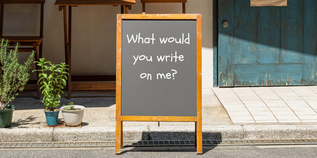 Blog 2 A board with the words 'What Would you write on me' to represent a blog about effective outdoor marketing