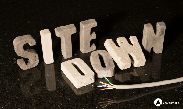 Blog 2 Concrete letters spelling 'Site Down' to accompany a blog about why your really wordpress website maintenance