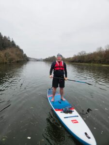 Project Demeter Alex Burrows on a paddle board to promote earth day