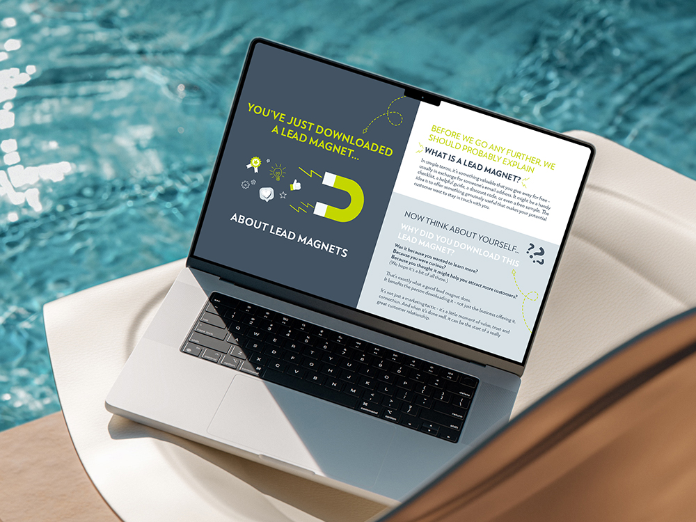 Blog 2 A MacBook by a pool side with Adventure Graphics Lead Magnet guide on the screen