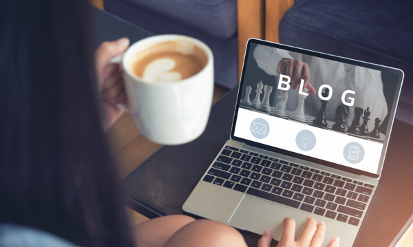 Image of laptop with the word 'blog' on it and a cup of coffee with a heart in the milk to accompnay a blog about way you need a blog on your website