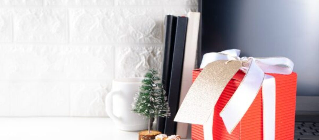 An office desk with a computer and Christmas items to accompany a blog about Christmas Marketing Ideas