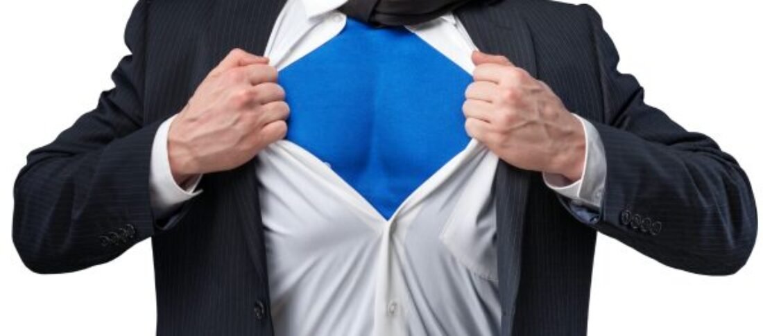 A man's torso in a suit jacket and tie opening his shirt like Superman showing a blue superhero suit to accompany a blog post about writing the perfect hero section website copy.