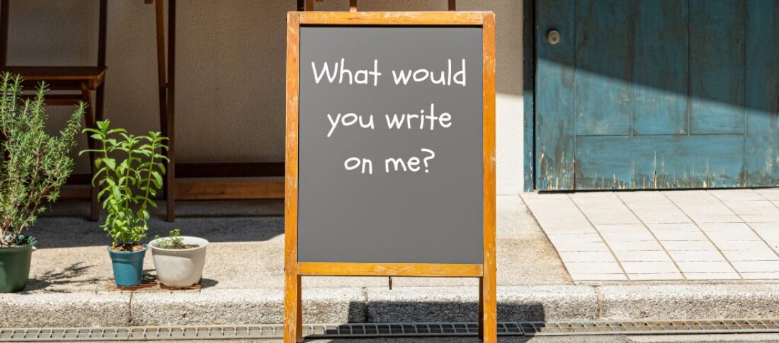 A board with the words 'What Would you write on me' to represent a blog about effective outdoor marketing